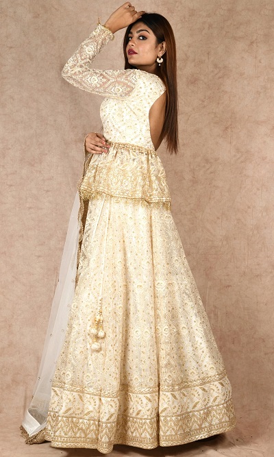 Beige peplum style lehenga blouse with net dupatta