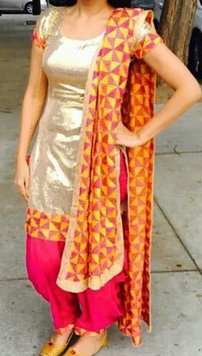 Gold suit with pink salwar and orange Phulkari dupatta
