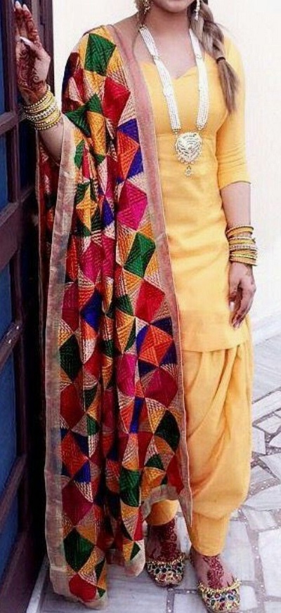 Pale yellow Punjabi short suit with multicolor Phulkari style dupatta