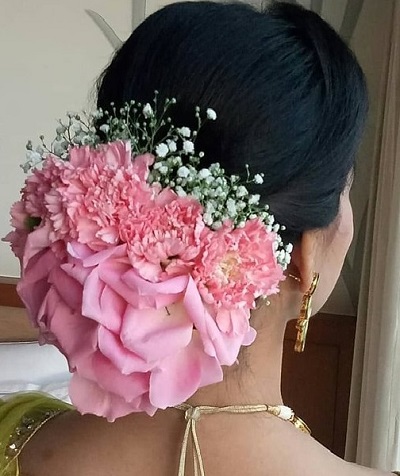 Flower covered low hanging bun for wedding