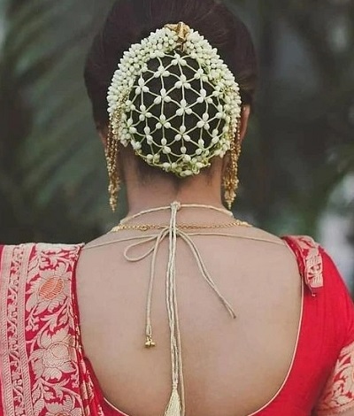 Netted gajra hairstyle covering the bun for lehenga