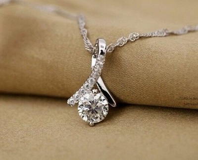 Solitaire diamond pendant with white gold design