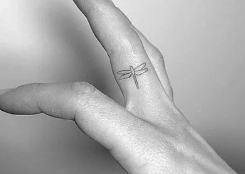 Delicate Firefly Finger Tattoo